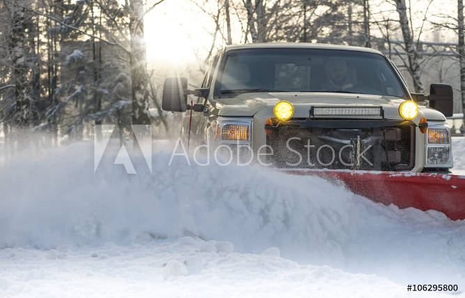 Four-wheel drive truck pushing snow